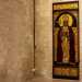 Specularmente al santo di Myra, alla fine del corridoio laterale, un affresco di San Gregorio del 1983 tinge con i suoi accesi toni rosso e oro la spenta muratura di fondo